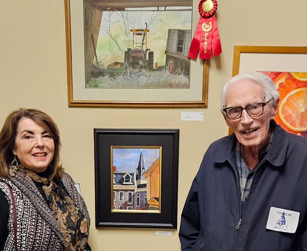 James Iams and Linda Luke with James' award-winning watercolor "Equipment Shed"
